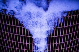 a heart shaped piece of metal with a lot of smoke coming out of it